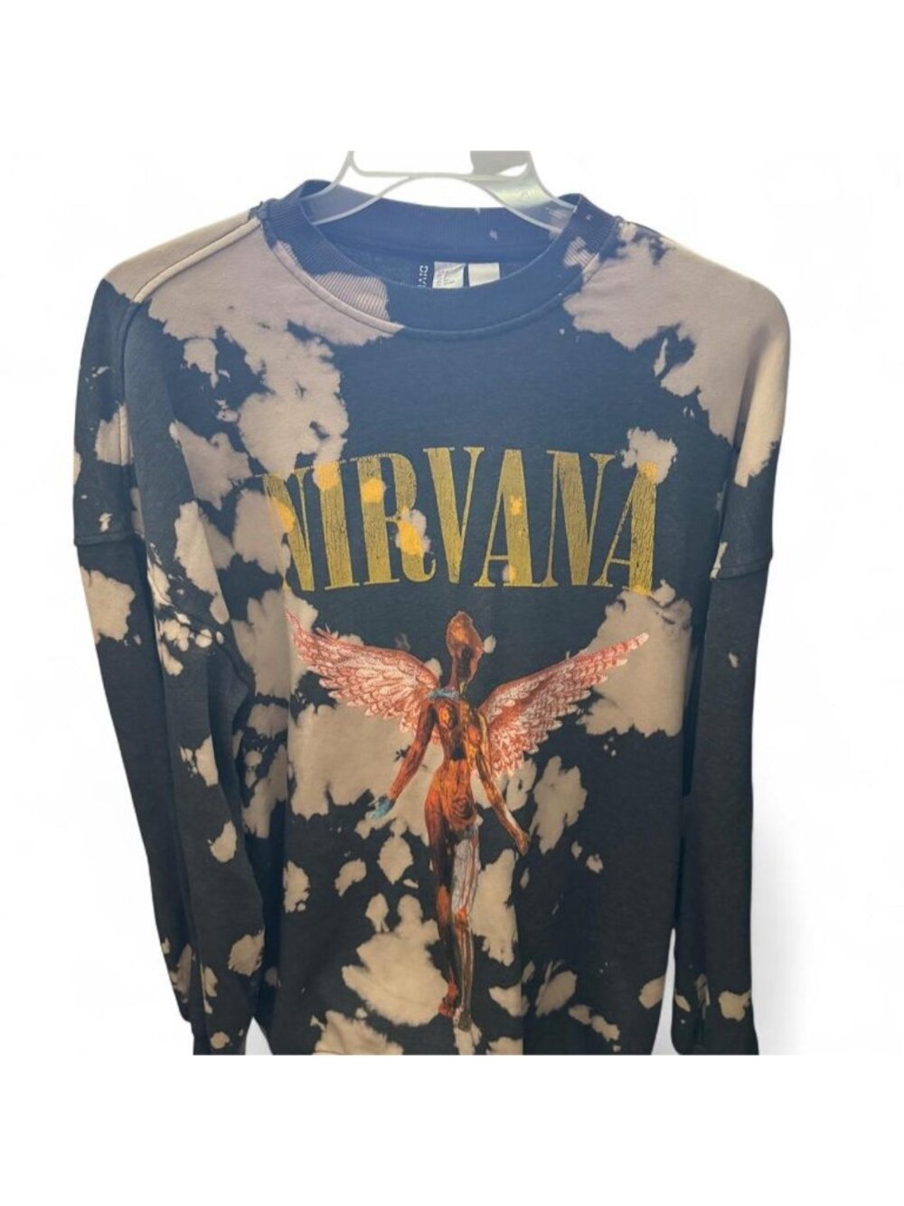 Nirvana H&M crewneck sweatshirt with gold 'NIRVANA' text and angel graphic